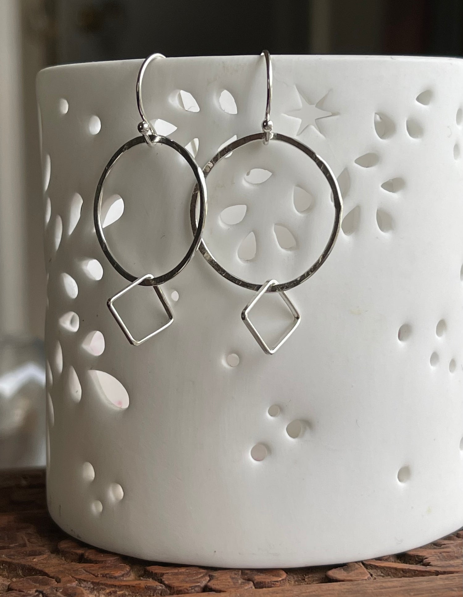 Sterling silver hoop earrings with small silver squares.