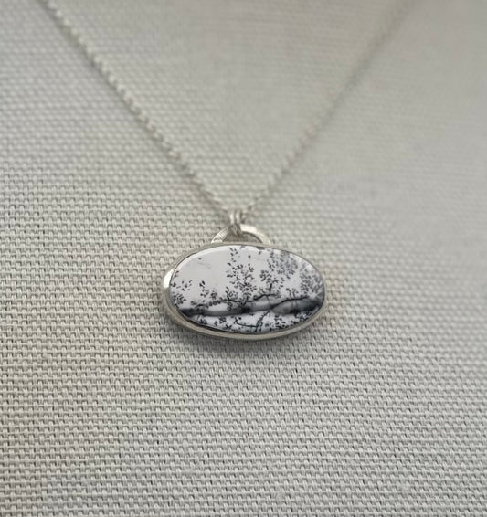 Dendritic (black and white) opal pendant in a sterling and fine silver bezel.
