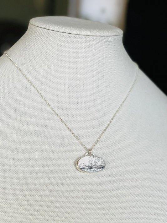 Dendritic opal pendant on a sterling silver chain. Opal has black markings on a white ground, like a snow scene.